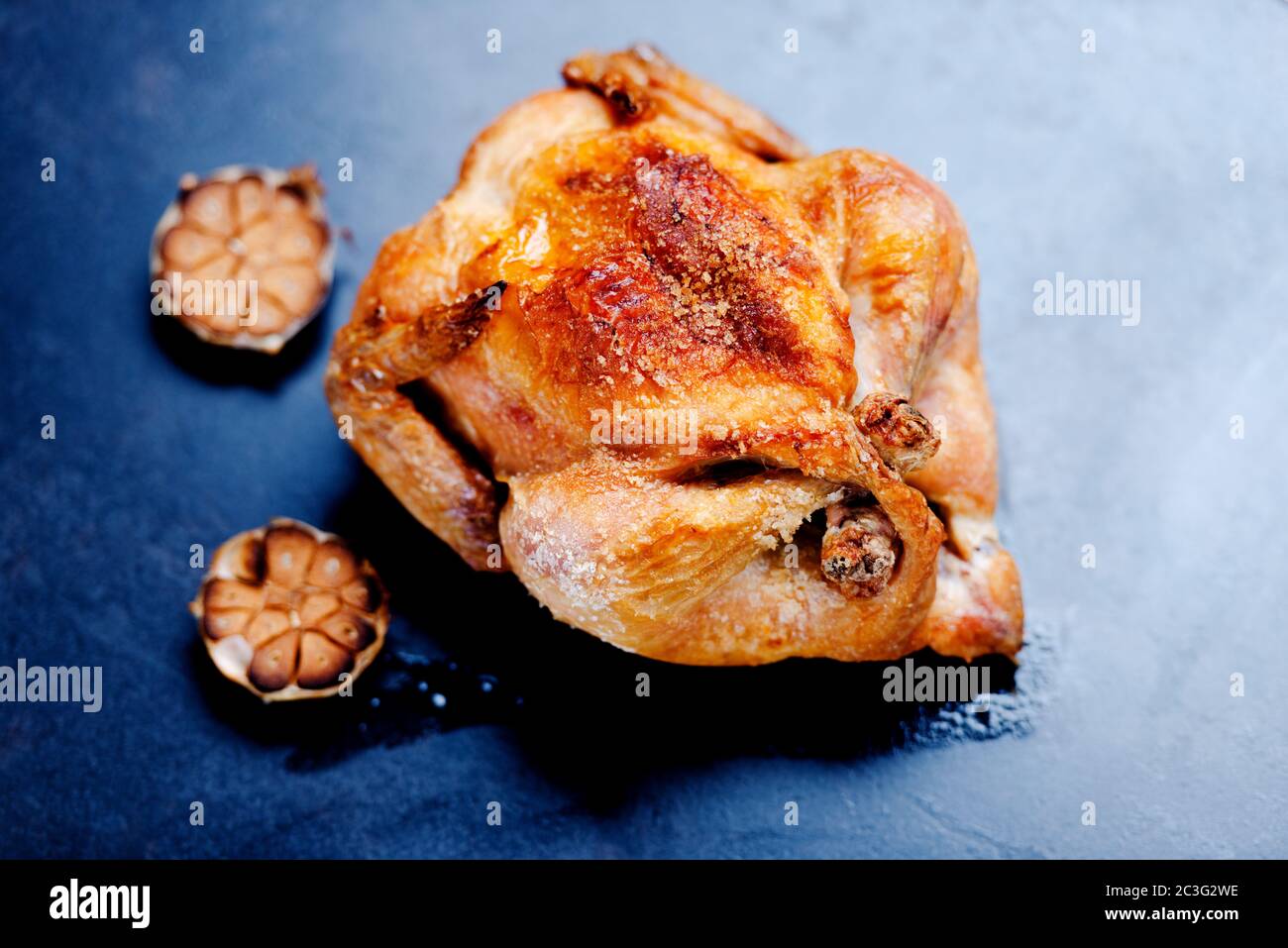 Whole oven roasted chicken with garlic Stock Photo - Alamy