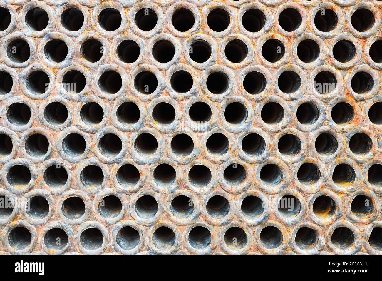 Tube sheet or plate of heat with welded tubes texture of stainless steel exchanger or boiler closeup texture vibrant colors background with insoluble Stock Photo
