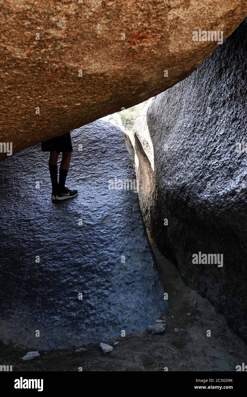 It is a tight squeeze to fit through Fat Man’s Pass, a hiking trail in Arizona. Stock Photo