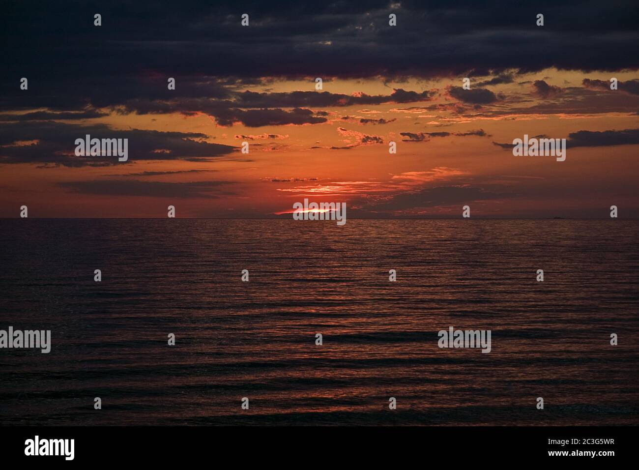 Beautiful scenery of the sunset sky with breathtaking clouds reflecting ...