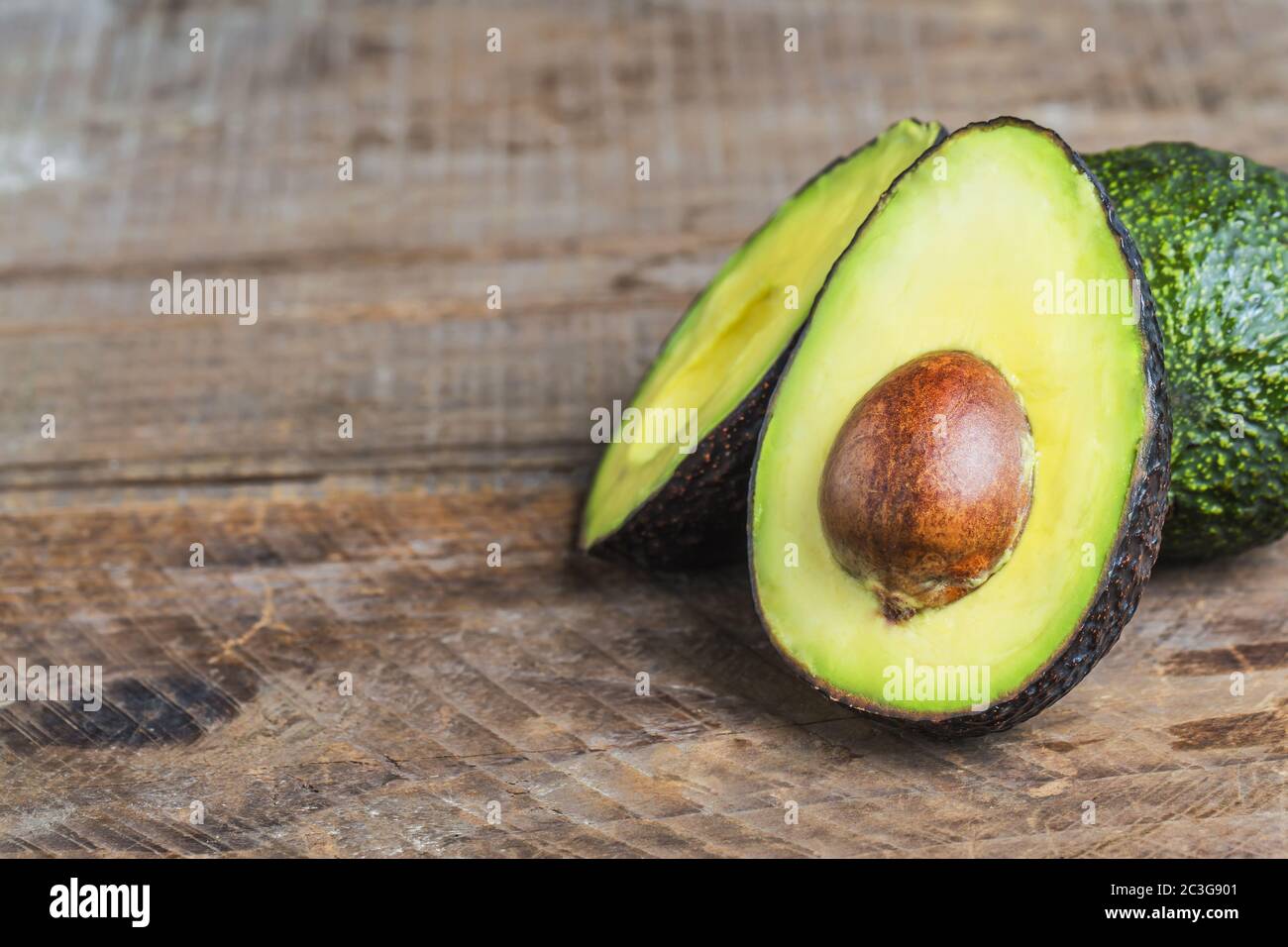 avocado on a dark wood background Stock Photo