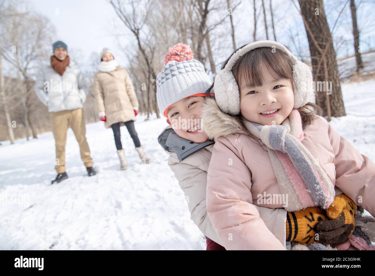 Happy family sledding in the snow Stock Photo - Alamy