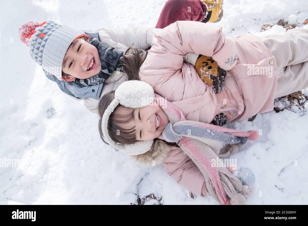 Two children playing in the snow Stock Photo - Alamy