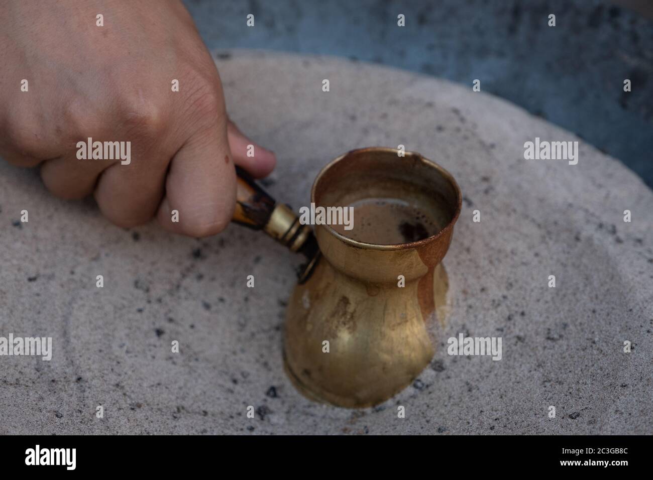 Preparation of desert arabic coffee on hot sand Stock Photo