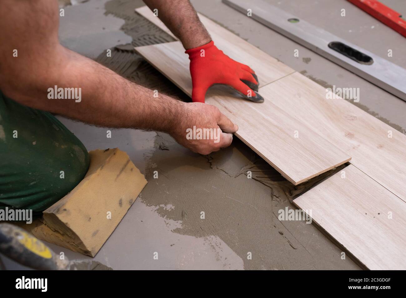 General construction worker. Adhesive for ceramic tiles. The builder