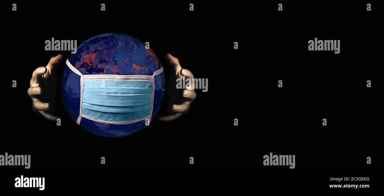 Coronavirus infecting the world, hands grasping the planet earth with a face mask Stock Photo