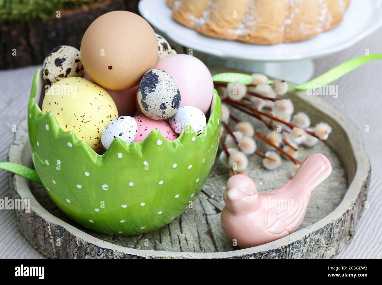 Easter table decorations with painted eggs and ceramic figurines. Festive time Stock Photo