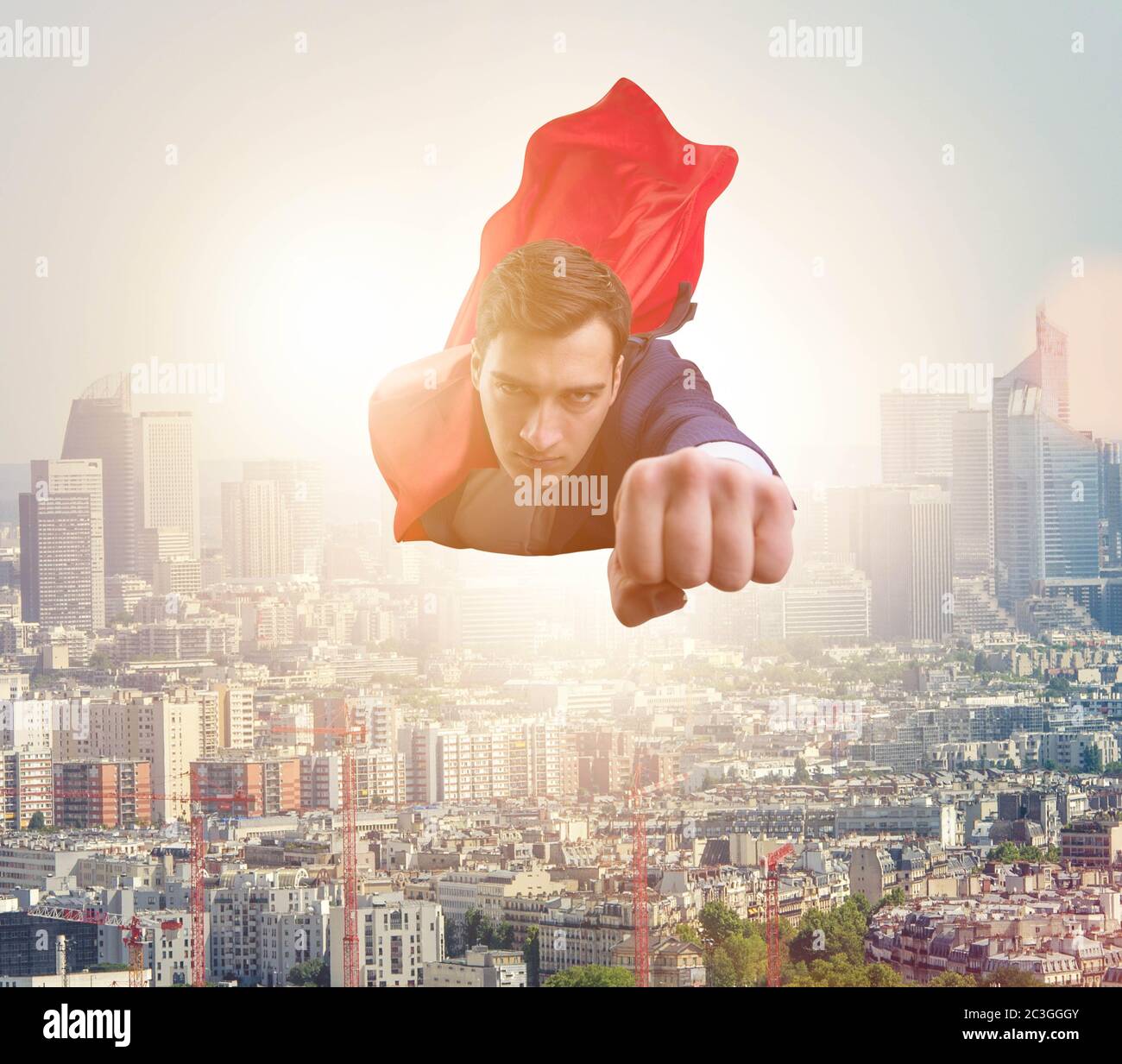 Superhero businessman flying over the city Stock Photo