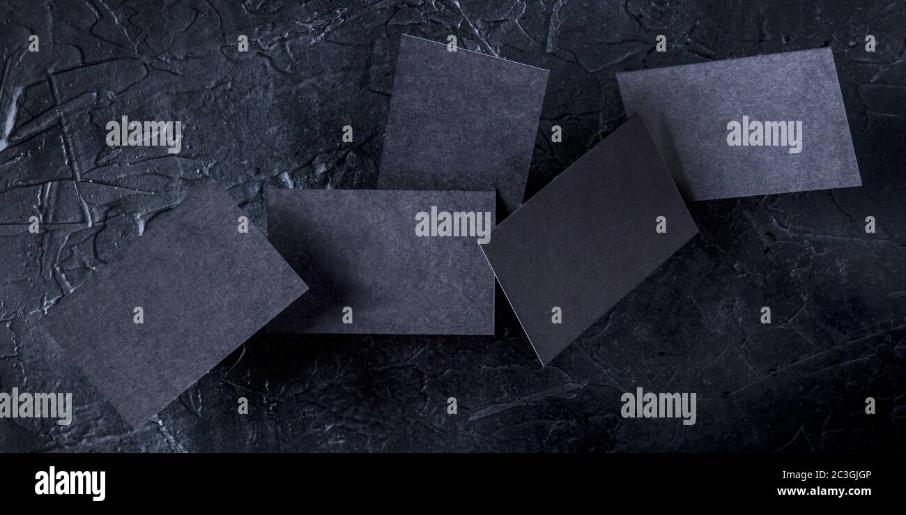 Thick black business cards panorama, flying on a dark background, a