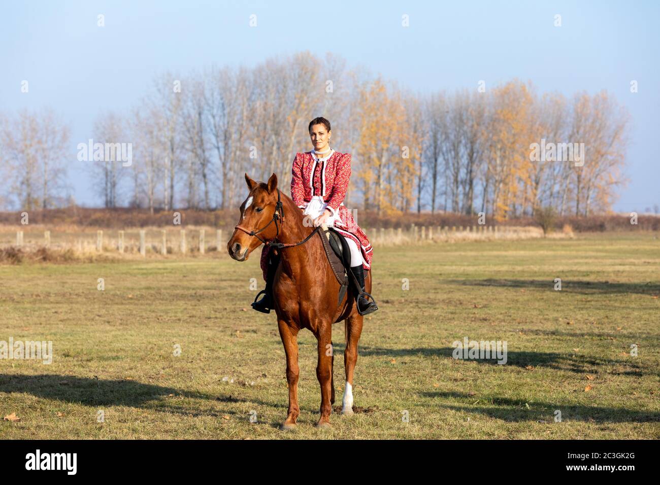 Hungarian csikos horsewoman in traditional folk costume Stock Photo