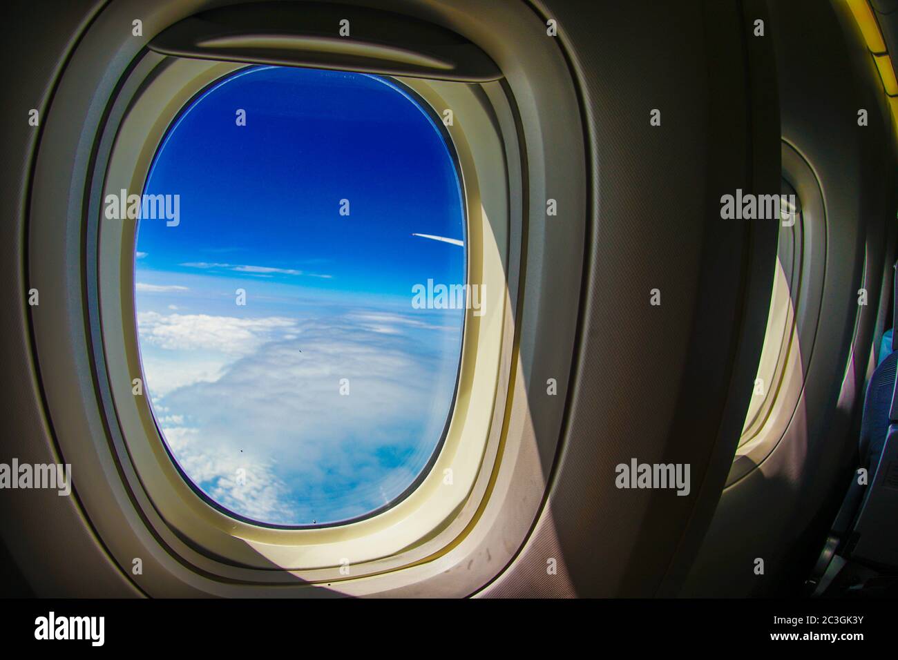 Clouds and sky visible from the window of an airplane Stock Photo - Alamy
