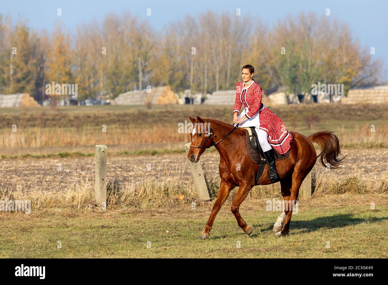 Hungarian csikos horsewoman in traditional folk costume Stock Photo