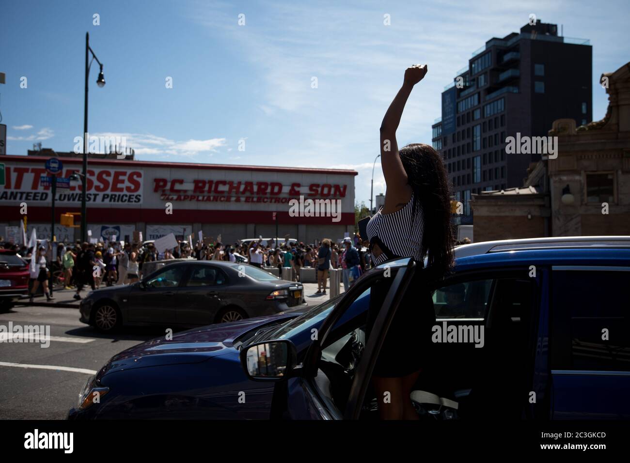 New York, USA. 19th June, 2020. A woman lifts her fist in the air during a 'Black Lives Matter' protest commemorating Juneteenth in the Brooklyn borough of New York, the United States, June 19, 2020. New Yorkers on Friday marked Juneteenth, the day commemorating the emancipation of enslaved African Americans, with marches and protests as the country is having a new moment of reckoning about racial injustice. Credit: Michael Nagle/WANG Ying/Xinhua/Alamy Live News Stock Photo