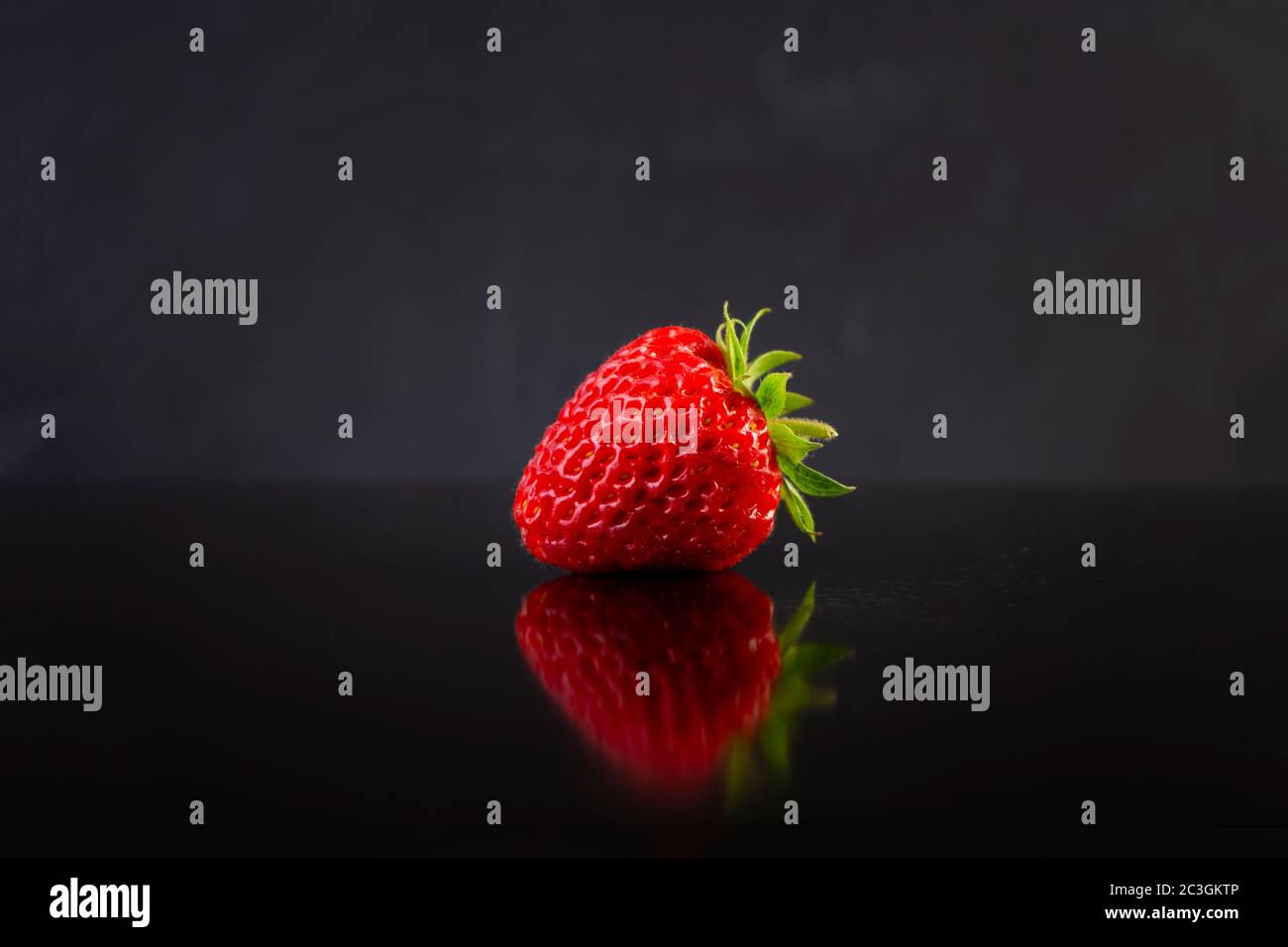 Sweet fresh ripe strawberry isolated on dark background Stock Photo - Alamy