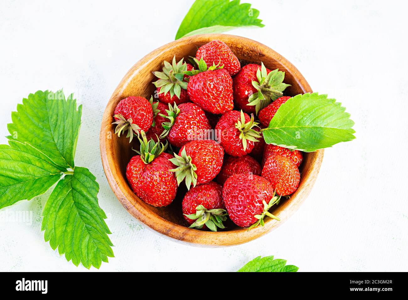 Sweet fresh ripe strawberry isolated on white wooden background Stock ...