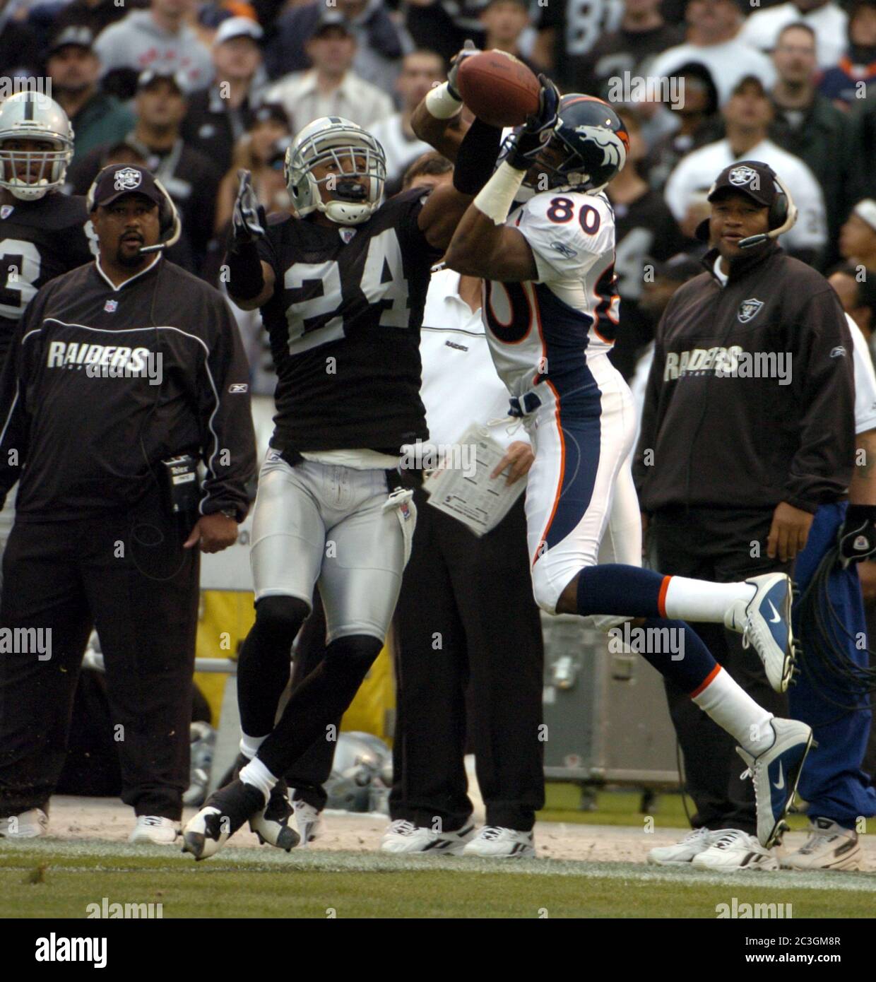 Oakland, United States. 17th Oct, 2004. Oakland Raiders cornerback Charles  Woodson breaks up a pass intended for Rod Smith of the Denver Broncos  during 31-3 loss at Network Associates Coliseum in Oakland,