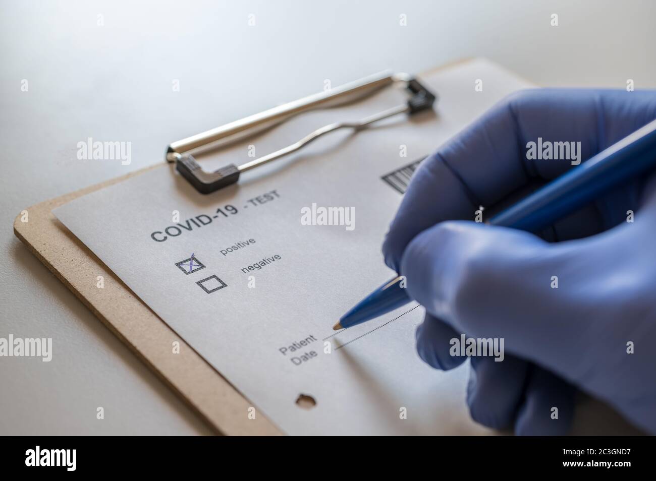 Doctor completes a patient's positive COVID-19 test Stock Photo