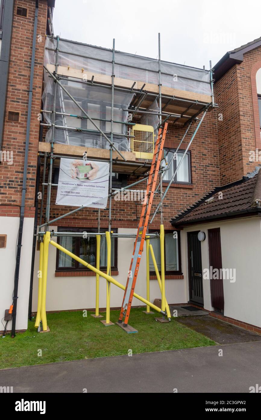 Scaffolding being used to install new windows on a residential property as part of the Heathrow Noise Insulation Scheme, Hounslow, West London, UK. Stock Photo