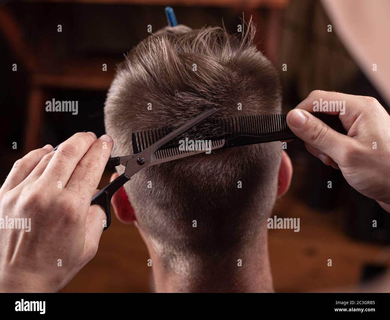 cutting hair with scissors at the hairdresser, pretty haircut. Stock Photo