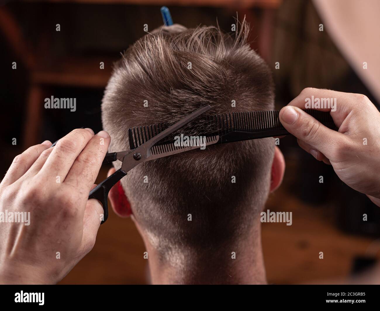 cutting hair with scissors at the hairdresser, pretty haircut Stock