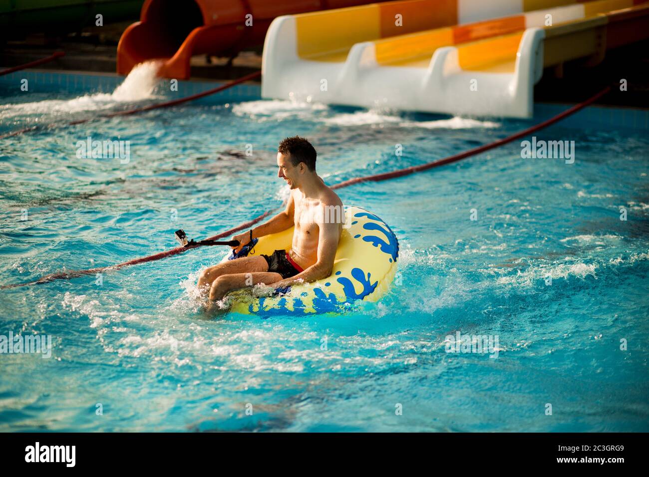 Happy person has active summer vacation activities at the water park