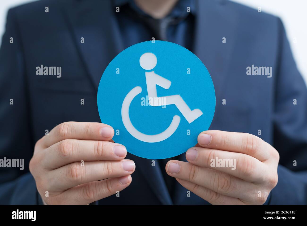 Icon of the person with disabilities made of paper in the hands of a ...