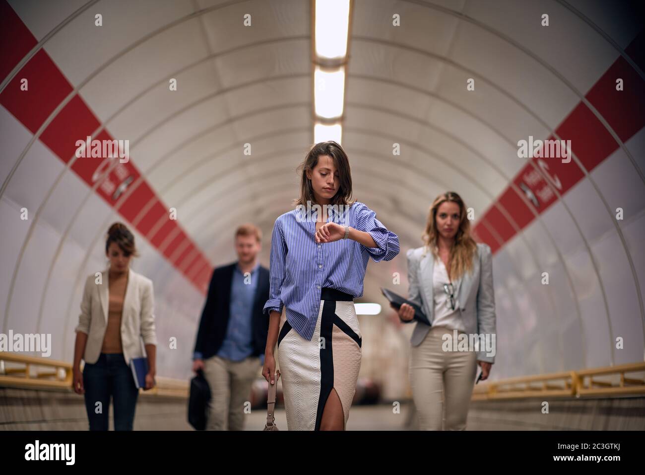 Modern business people walking to platform at train station.Urban lifestyle and transportation concepts. Stock Photo