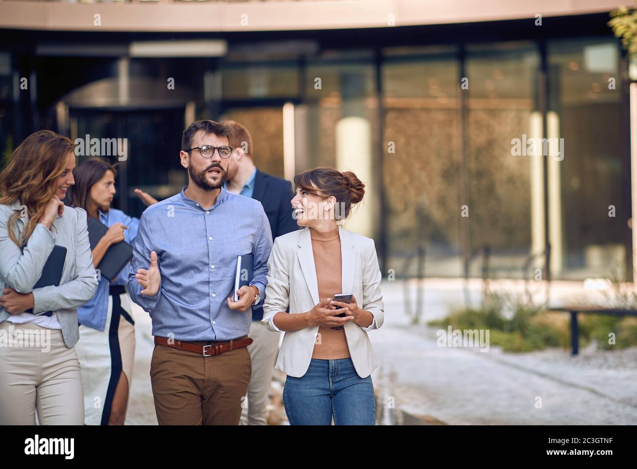 cropped image of caucasian businesspeople  walking, talking and laughing Stock Photo