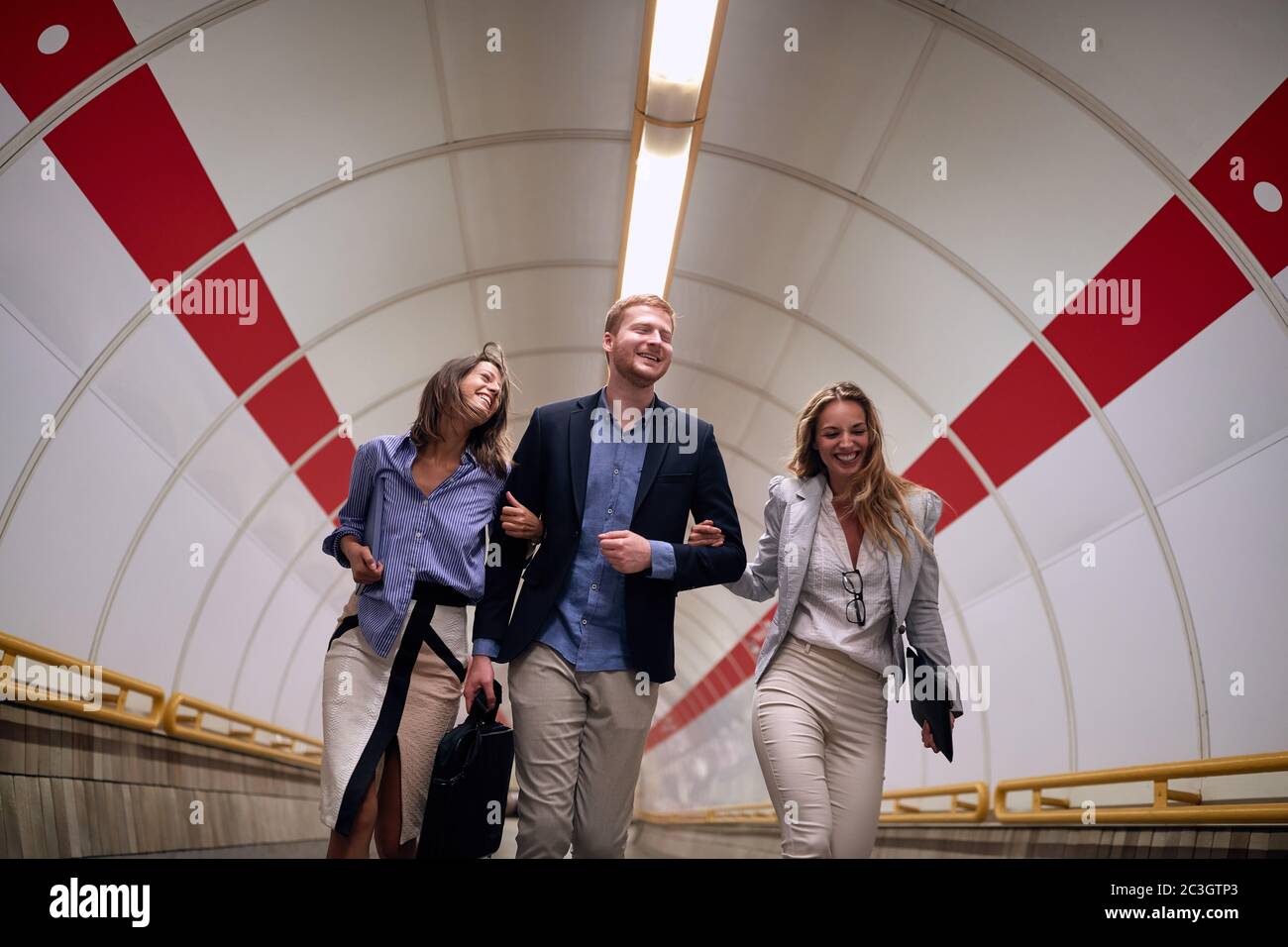 Group of successful young business people going to work  with metro station. Stock Photo