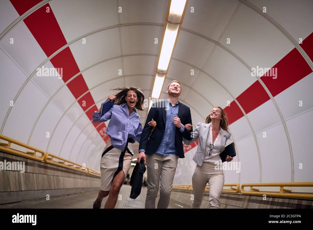 successful young business people going to work  with metro station. Stock Photo
