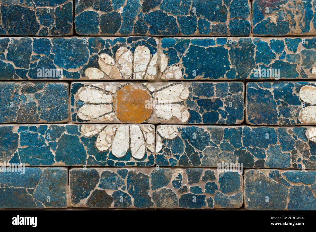 damaged brick wall with simple flower image from ancient Babylon Stock Photo