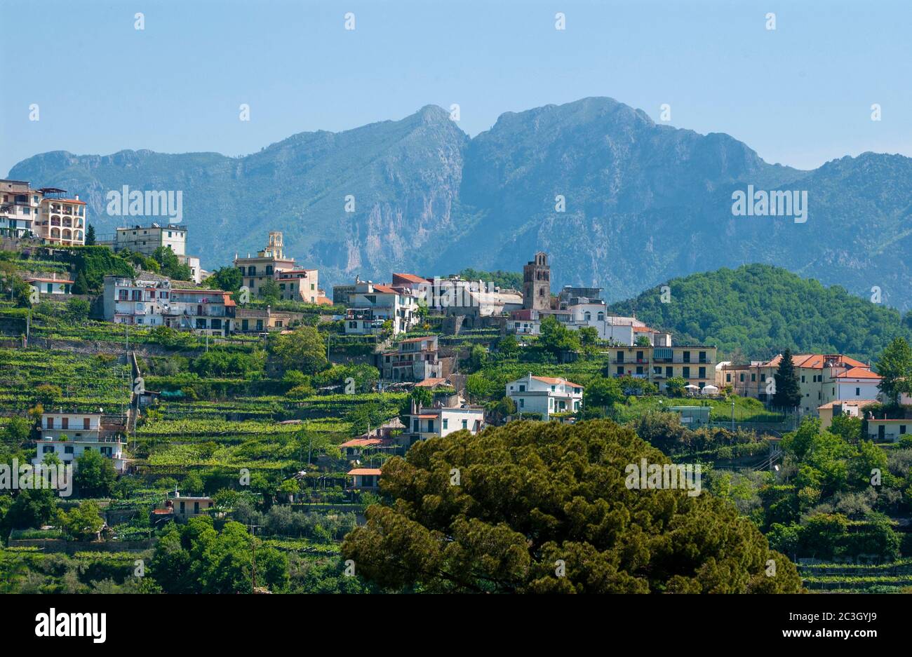 Houses  and buildings on the terraces on the outskirts   of Ravello with the  Mountains surrounding the Historic town of Ravello behind Stock Photo