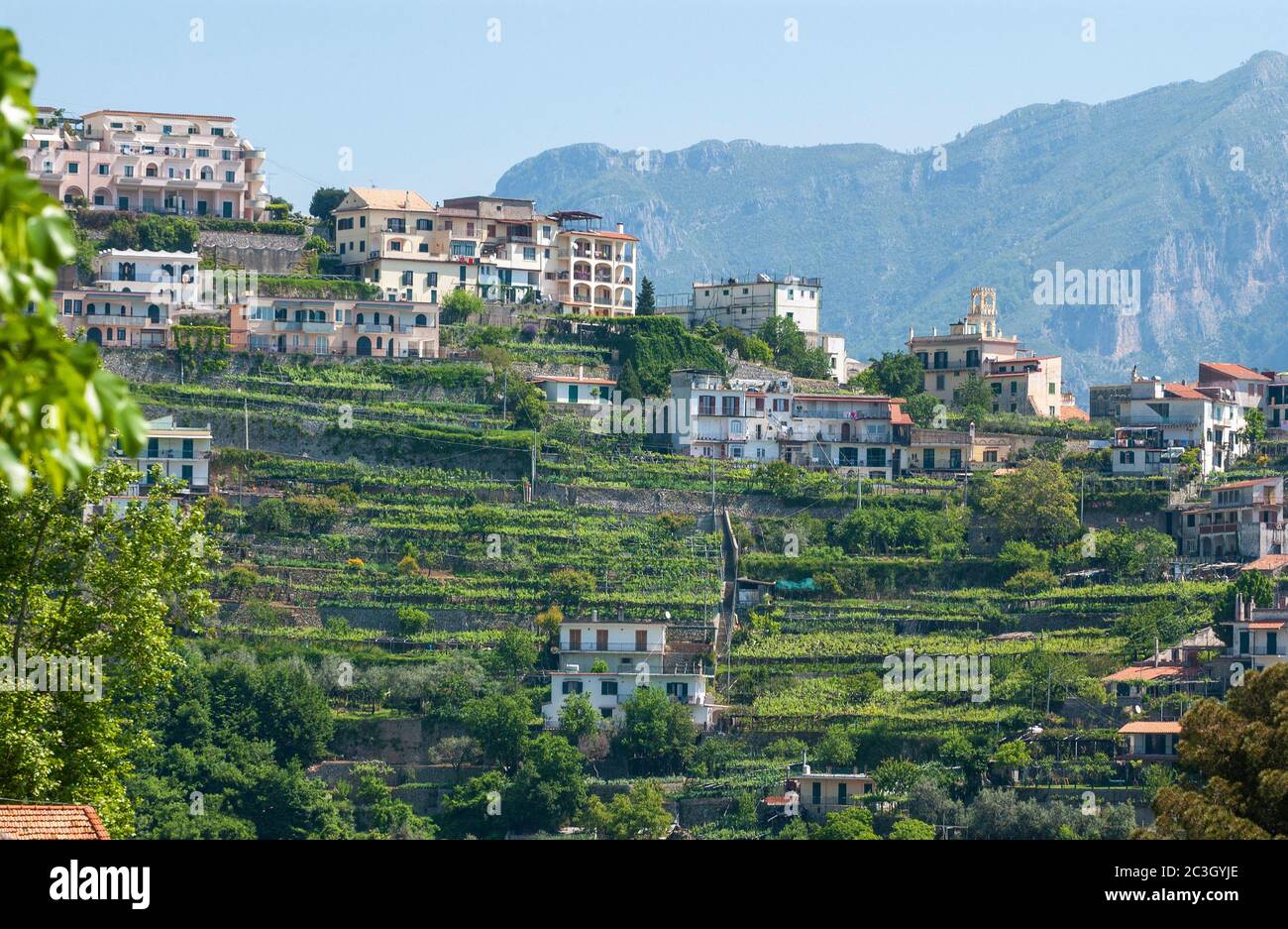 Houses  and buildings on the terraces on the outskirts   of Ravello with the  Mountains surrounding the Historic town of Ravello behind Stock Photo