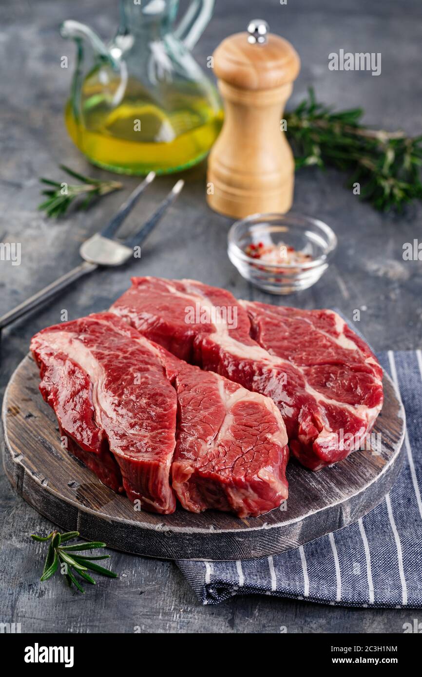 Raw beef steak on dark gray background Stock Photo