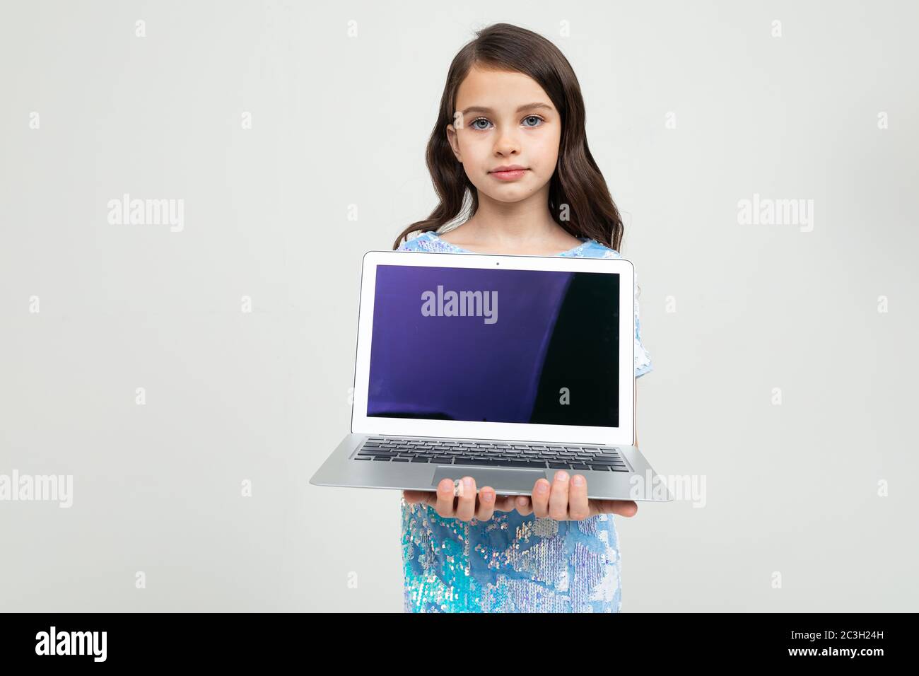 teen-girl-holding-a-laptop-with-a-blank-screen-to-insert-a-website-on-a