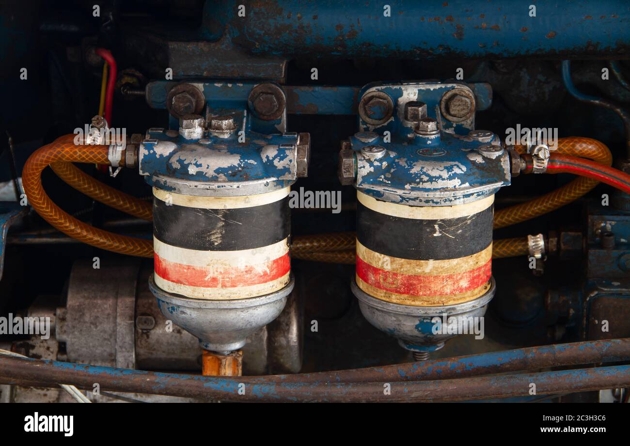 Fuel oli and hydraulic fluid filters on modern tractor engine, farming