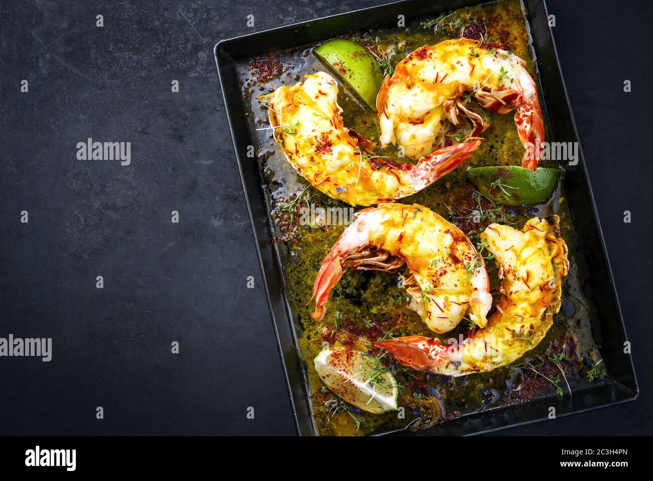 Traditional barbecue spiny lobster tail sliced and offered with saffron