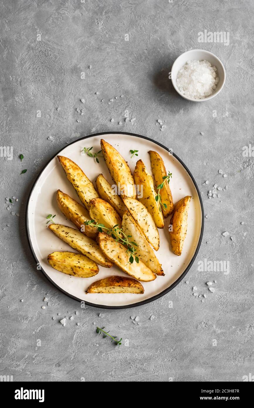 Roasted Potato Wedges With Herbs And Sea Salt On Plate Top View Copy Space Homemade Oven Baked Potato Snacks And Sour Cream Sauce Stock Photo Alamy