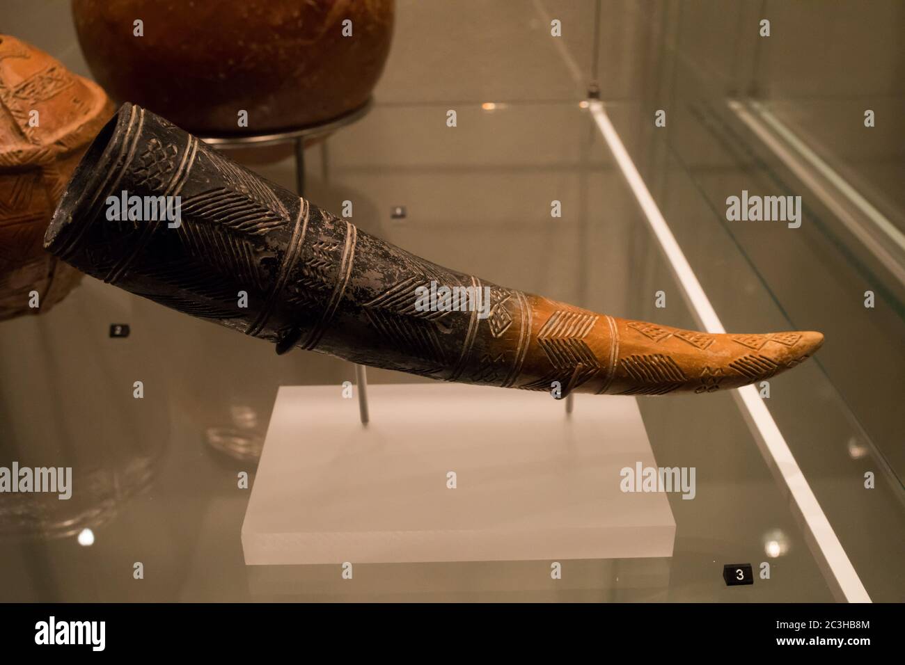 Leiden, The Netherlands - JAN 04, 2020: closeup of a decorated drinking horn from ancient Cyprus with symbols carved in it. Stock Photo