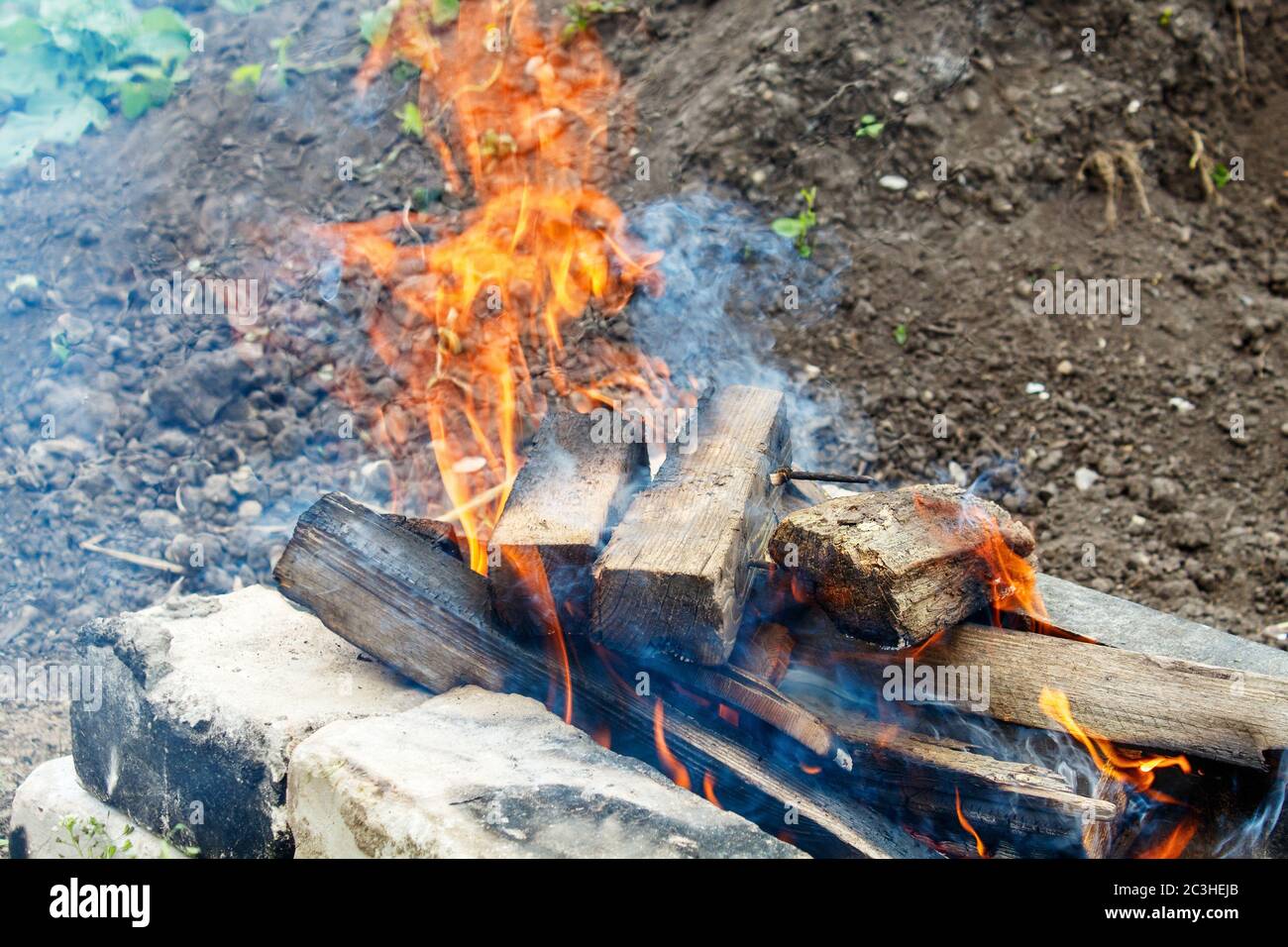 sawn wooden bars burn in a fire outdoor closeup Stock Photo - Alamy
