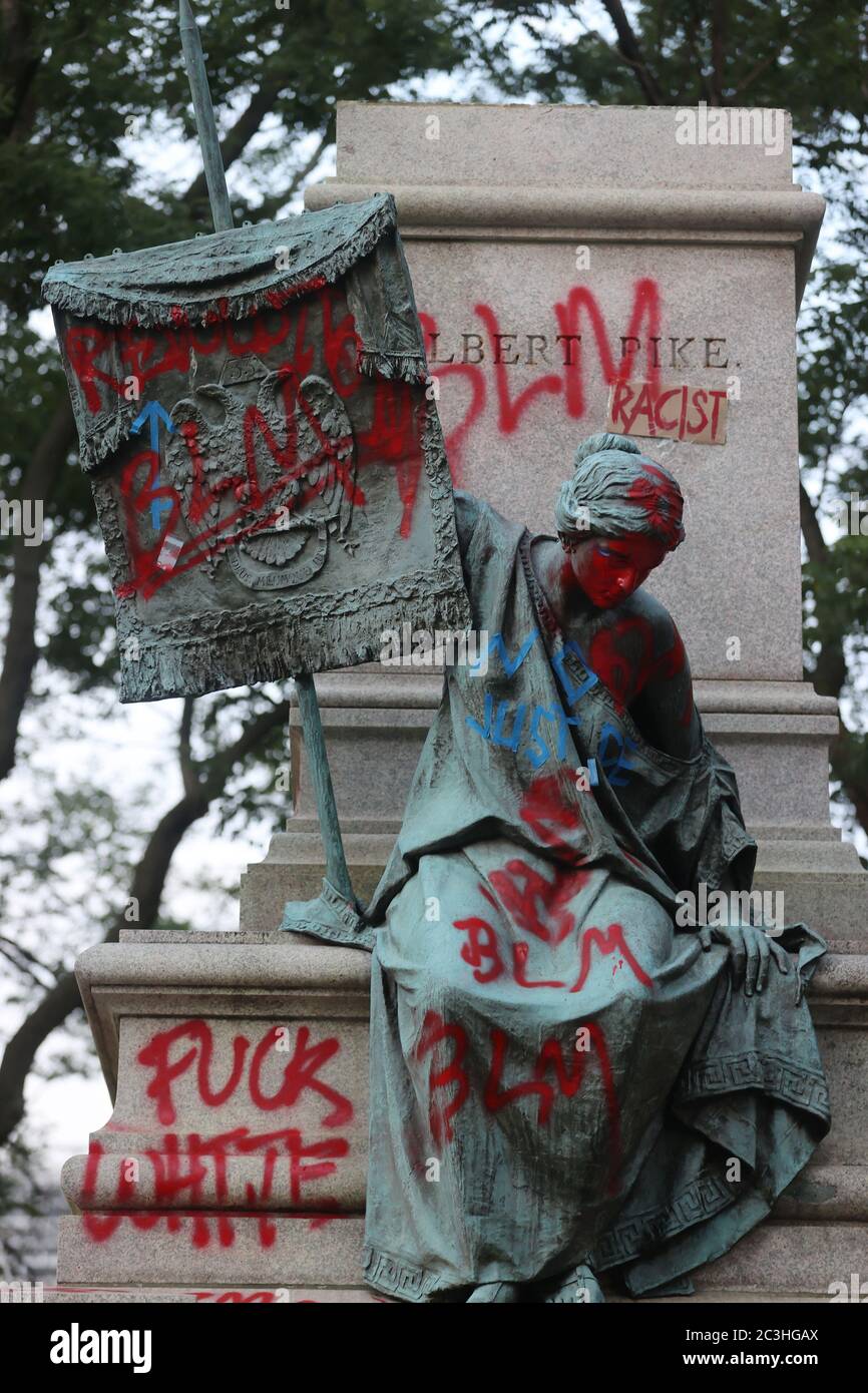 WASHINGTON, D.C. - JUNE 20: View of a defamed and toppled Statue of Confederate Albert Pike, toppled overnight by protestors outside of Judiciary Square one street over from DC Police Headquarters. June 20, 2020 in Washington, D.C. Credit: mpi34/MediaPunch Stock Photo