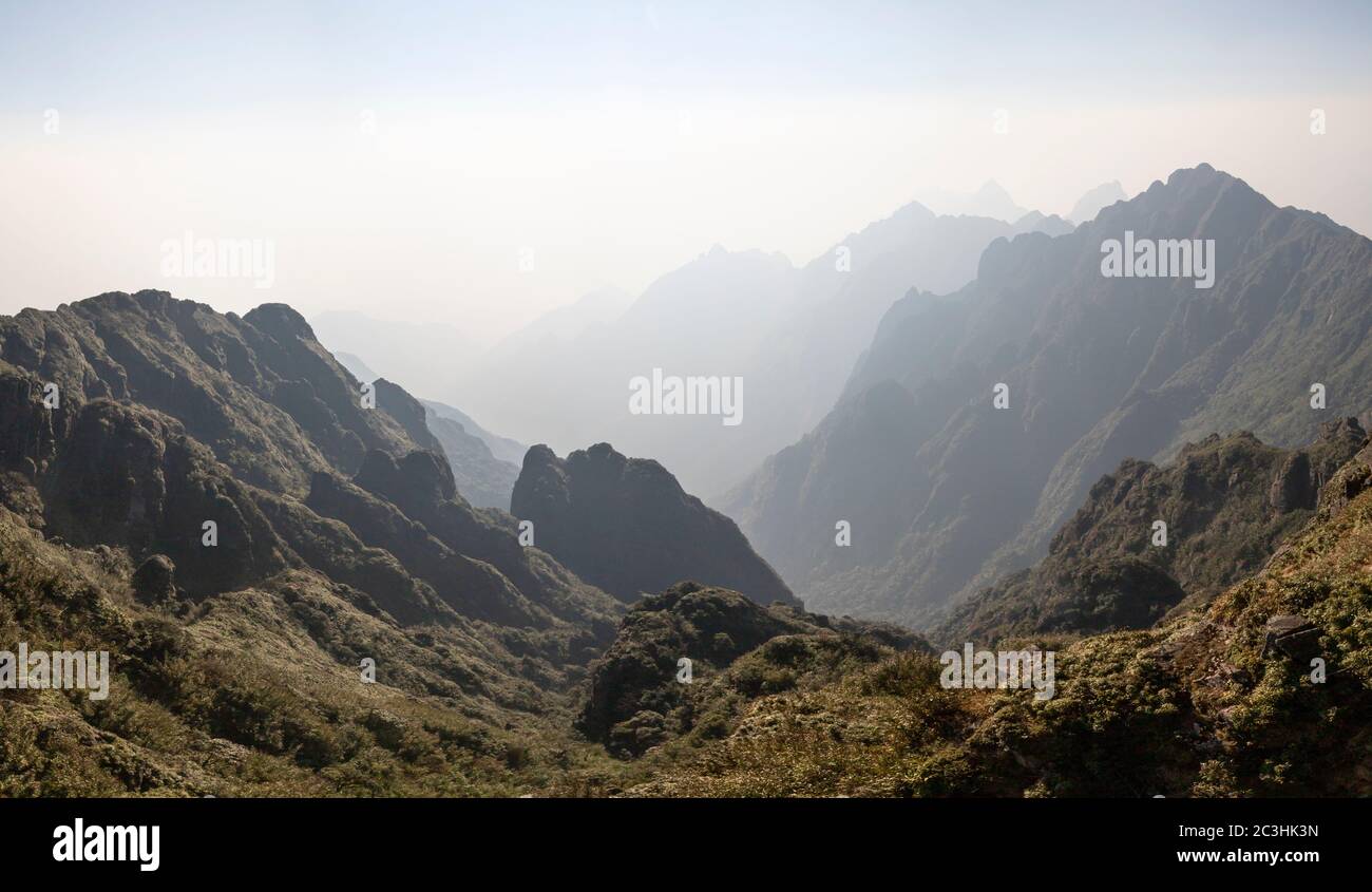 View towards China from the top of Fansipan mountain in Vietnam, southwest of Sa Pa in the Hoang Lien Son mountain range."The Roof of Indochina" Stock Photo