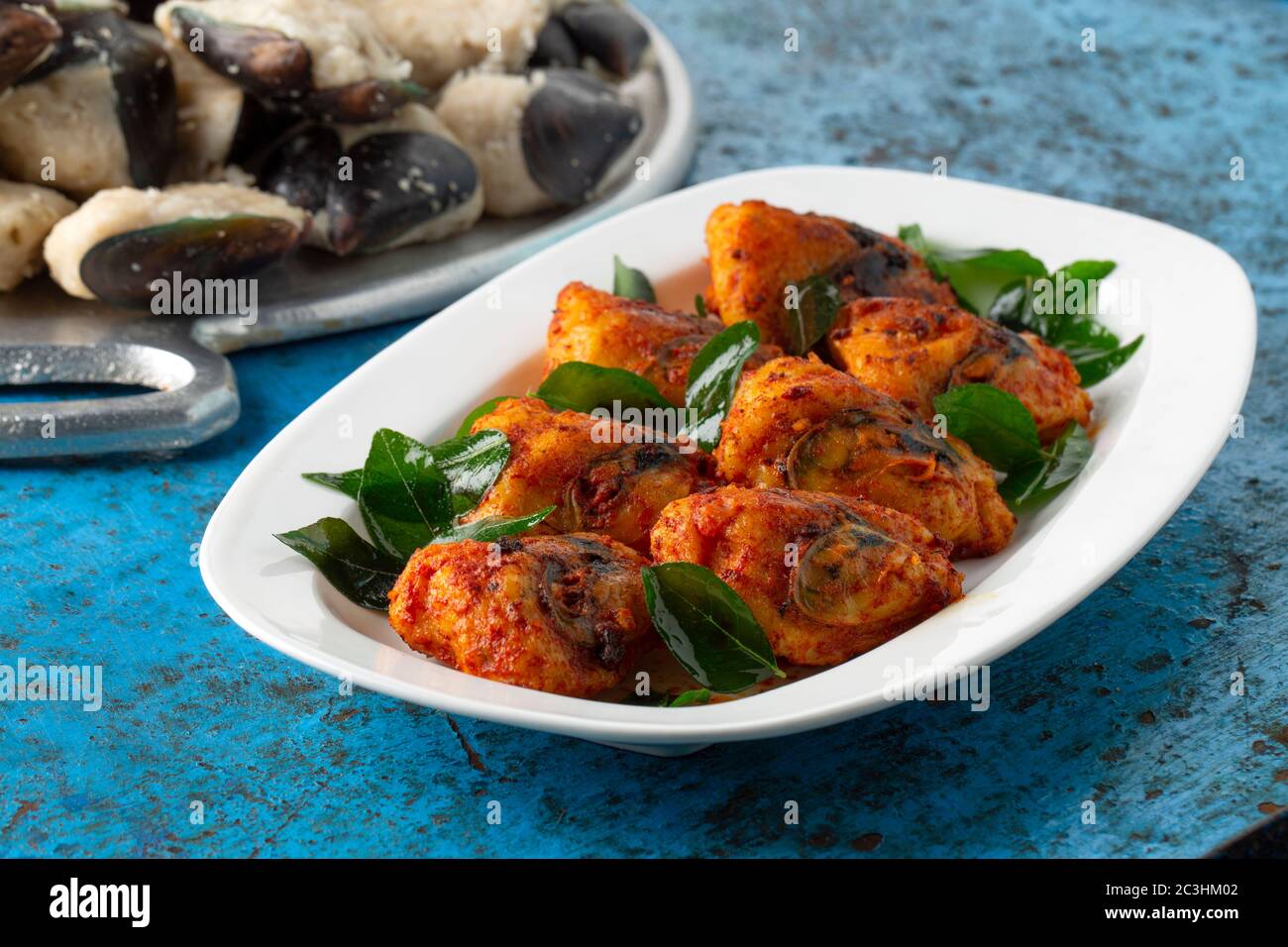 Kerala Stuffed Mussels fry _kerala special snack rice batter stuffed mussels fry,tasty street food with dry ginger coffee with blue background,selecti Stock Photo
