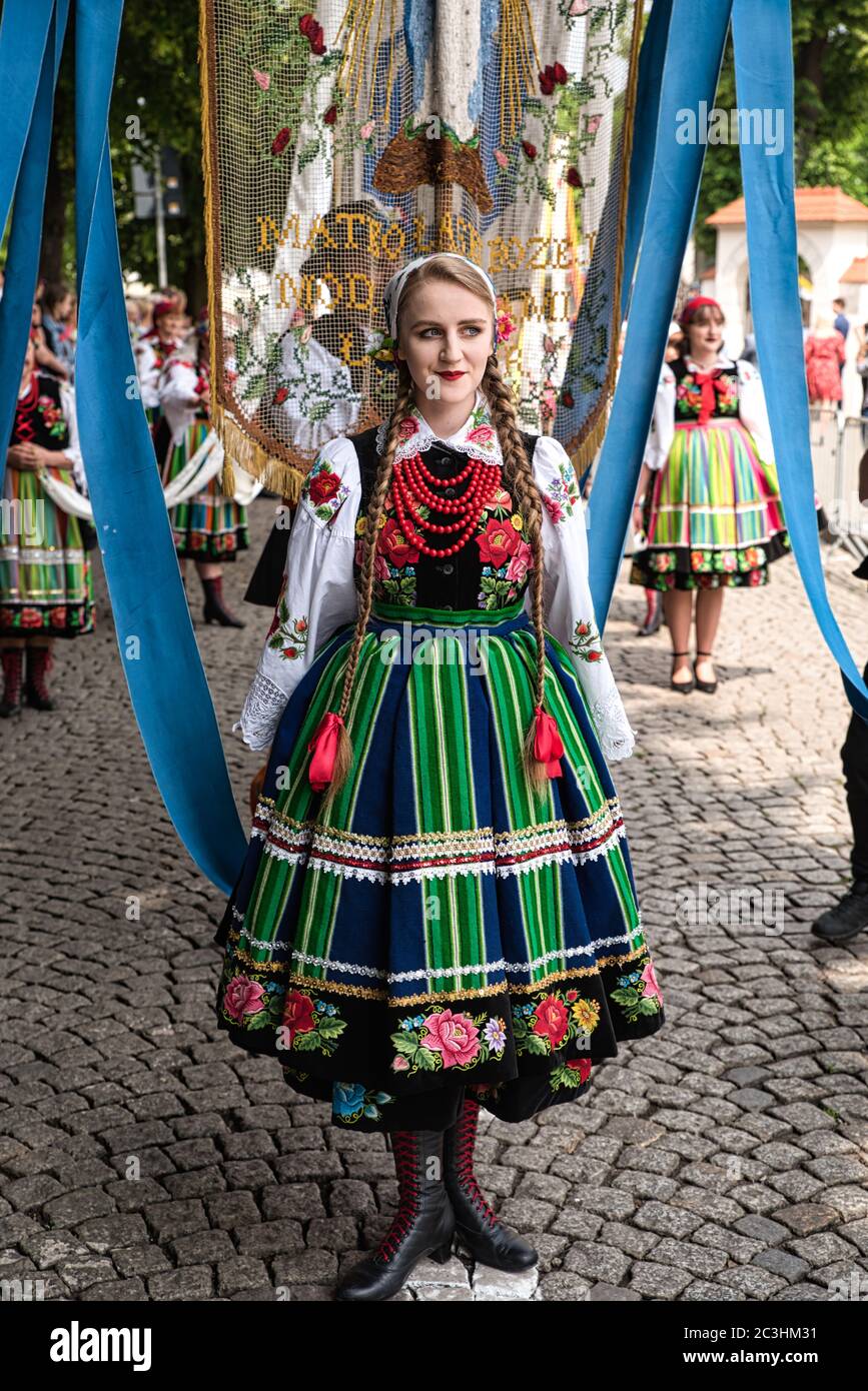 Lowicz, Jun 11, 2020: Girl dressed in polish national folk costume from Lowicz region during Corpus Christi procession. Polish folk dress Stock Photo