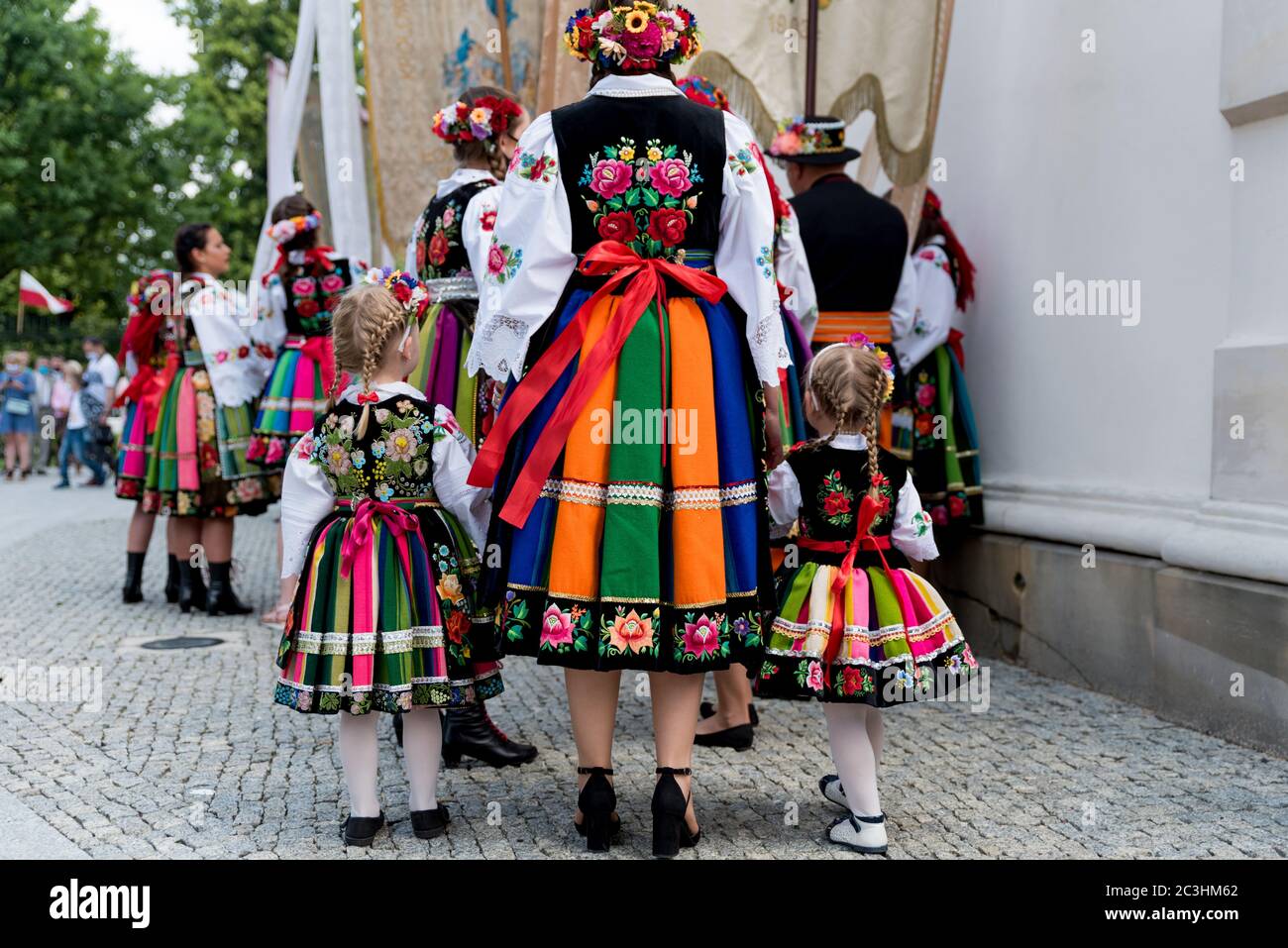 Lowicz, Jun 11, 2020: People dressed in polish national folk costumes from Lowicz region during annual Corpus Christi procession. Close up of traditio Stock Photo