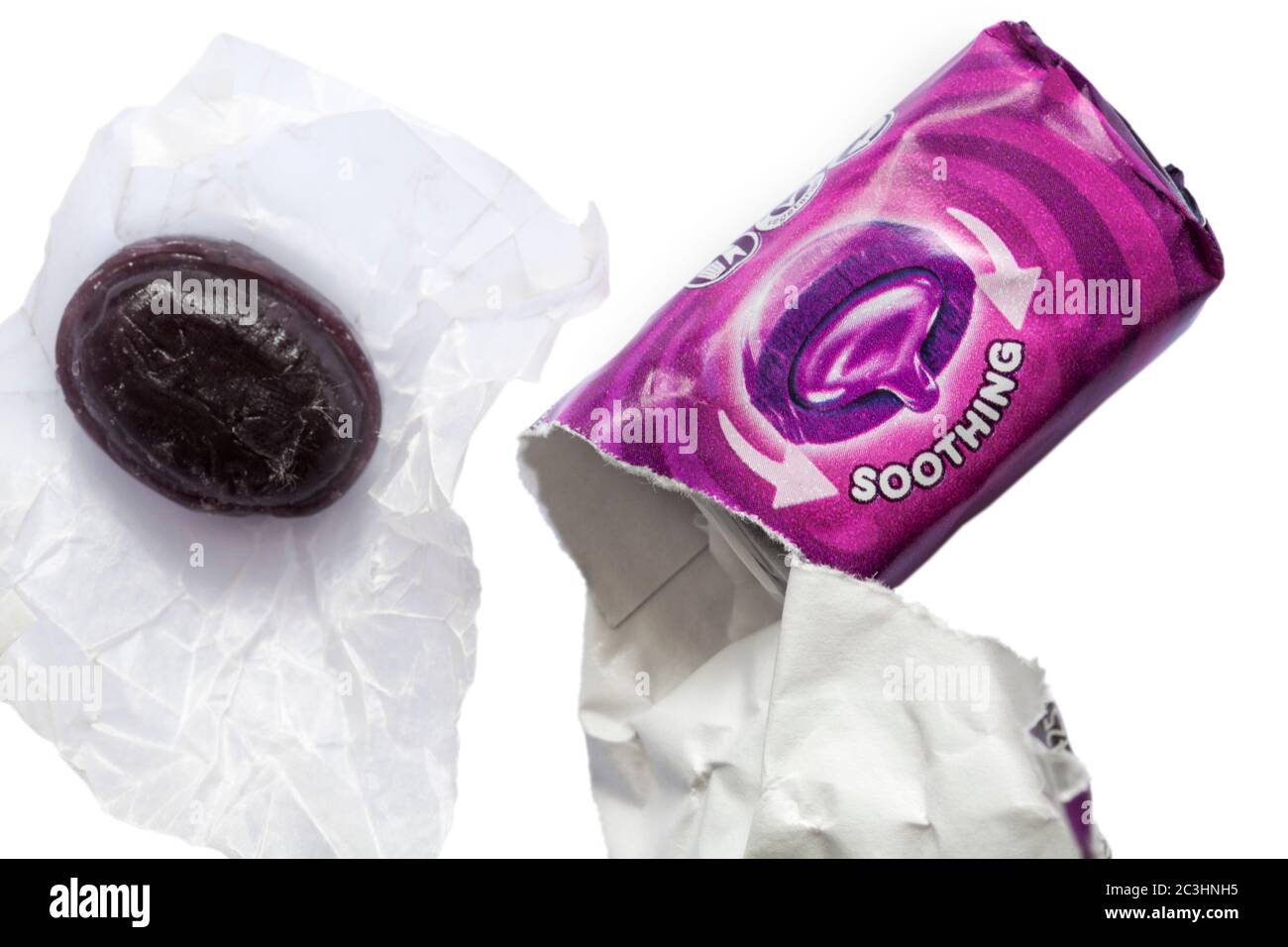 soothing Halls Soothers sweets blackcurrant flavour with sweet removed from packet and unwrapped set on white background Stock Photo