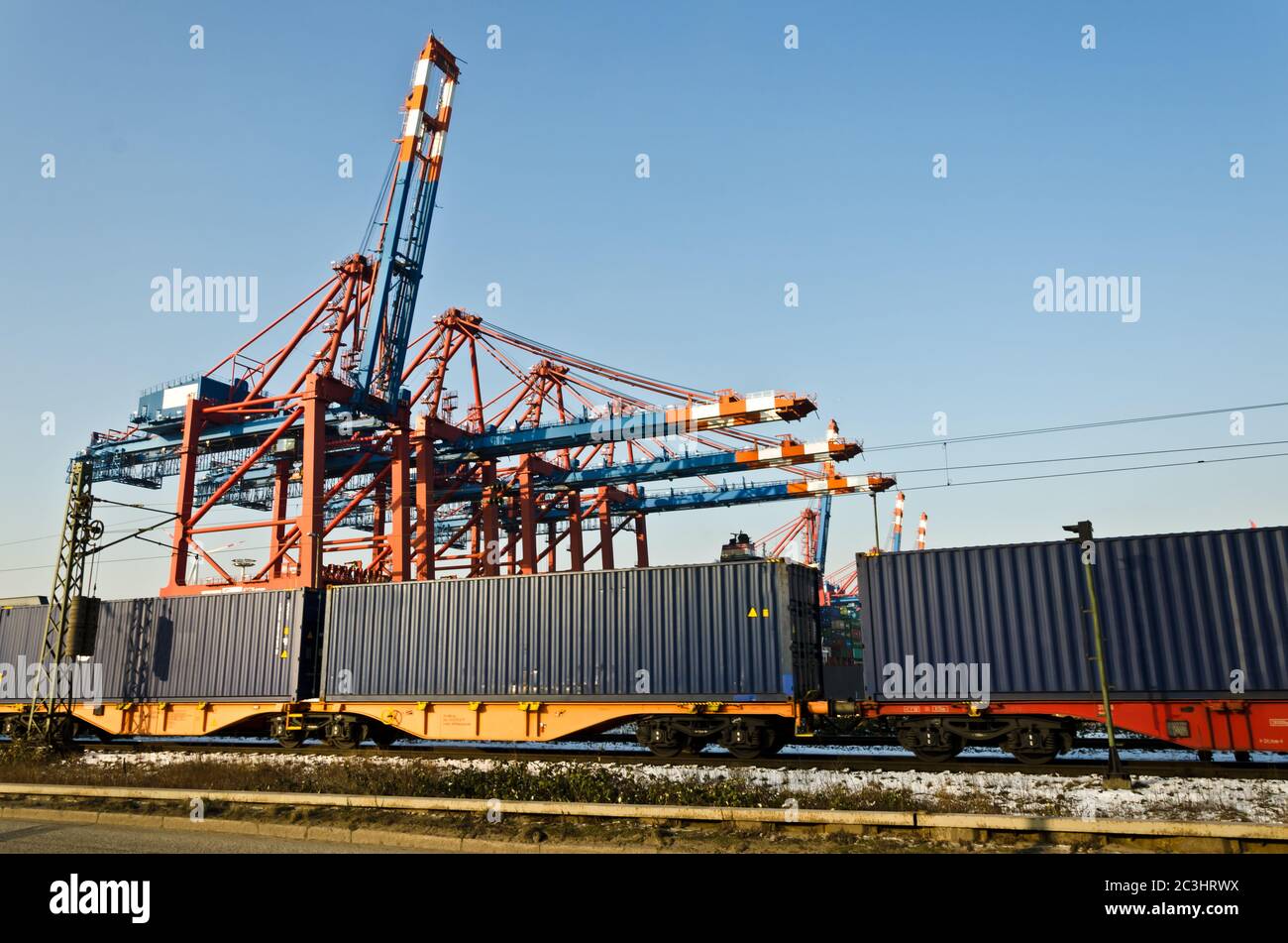 Freight train and harbour cranes Stock Photo