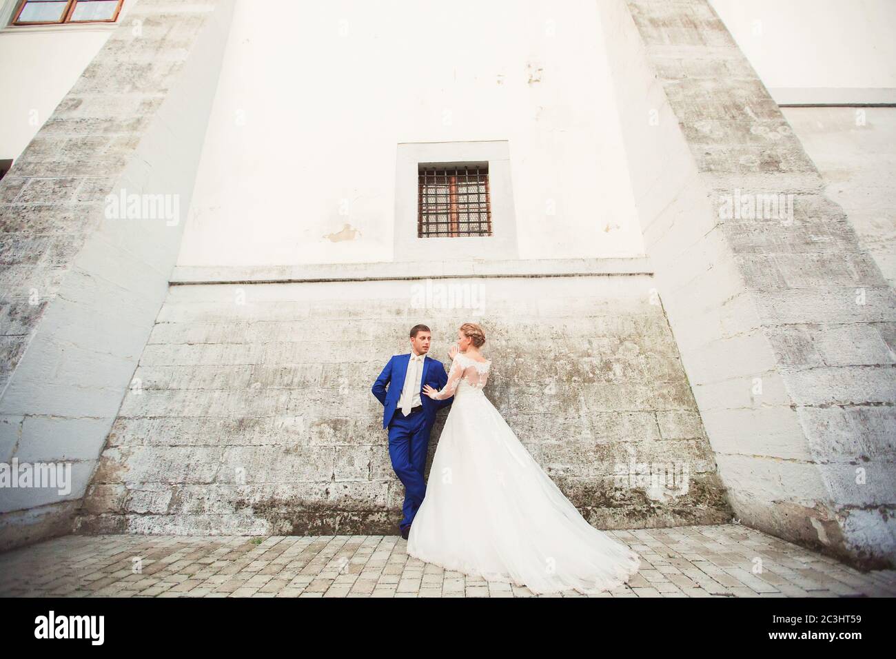 bride and groom walk around the old town Stock Photo - Alamy