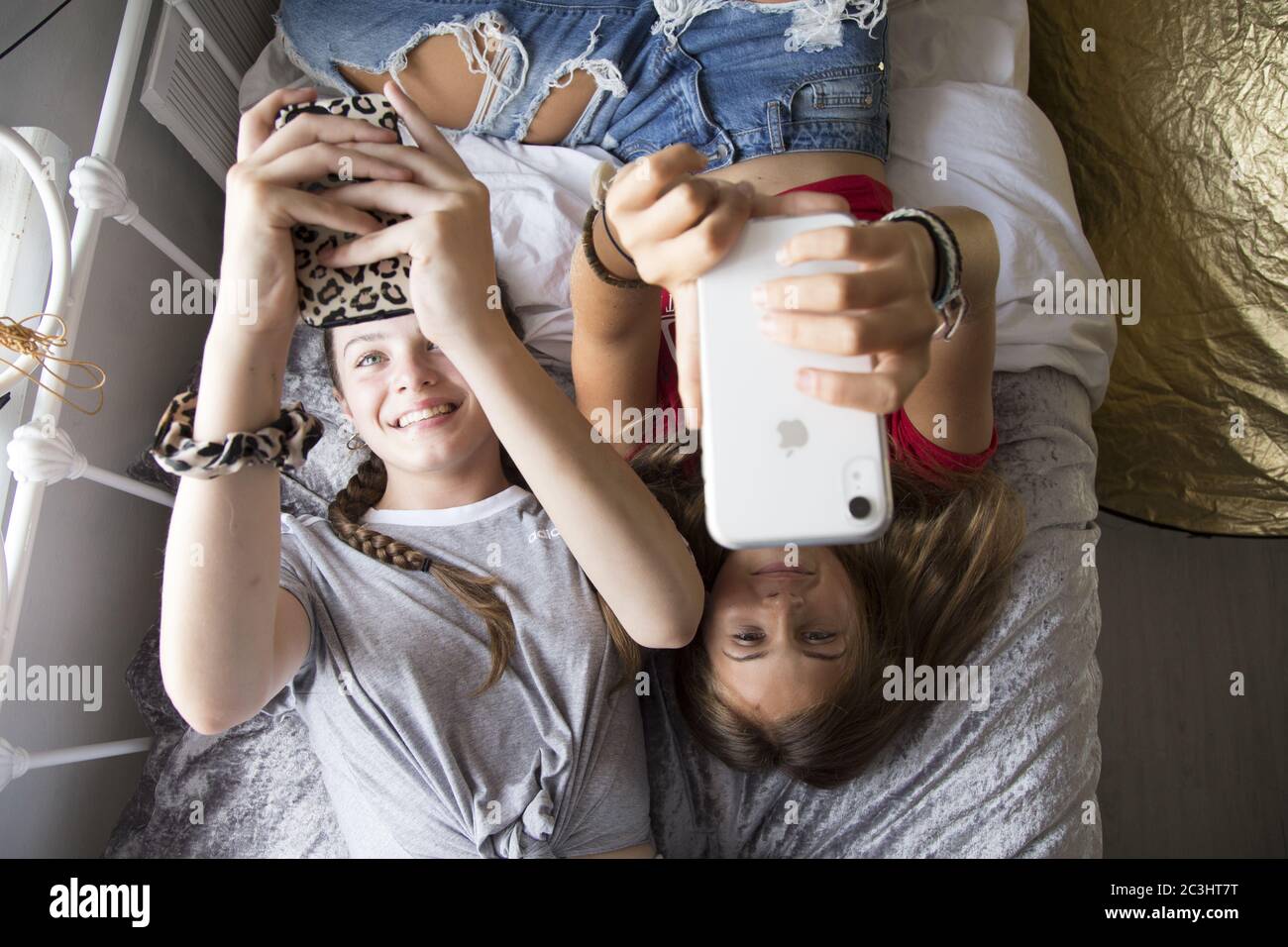 CANTERBURY, UNITED KINGDOM - Aug 29, 2019: Teenage Girls, Best friends hanging out but spending all of their time on their phones. Stock Photo