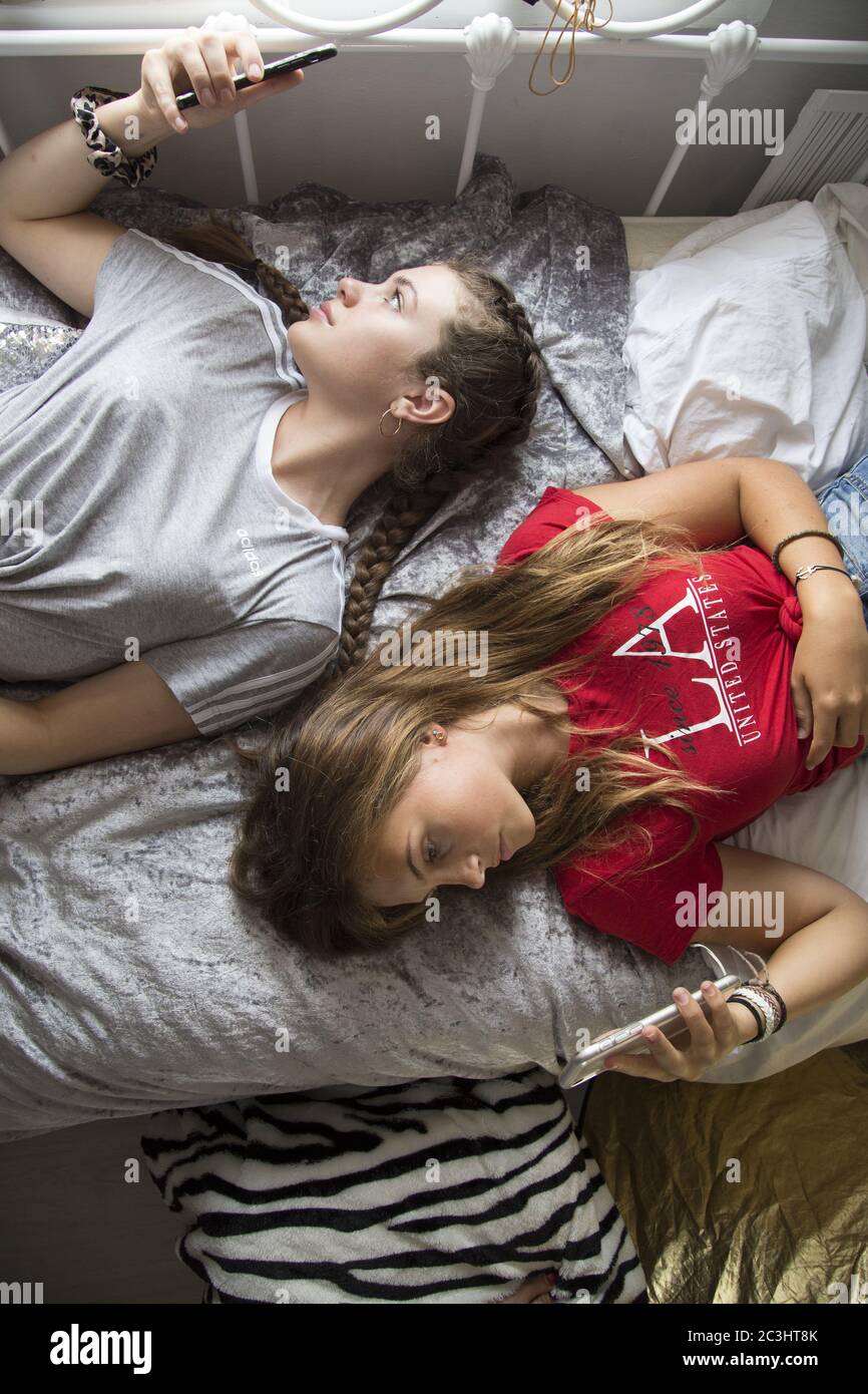CANTERBURY, UNITED KINGDOM - Aug 29, 2019: Teenage Girls, Best friends hanging out but spending all of their time on their phones. Stock Photo